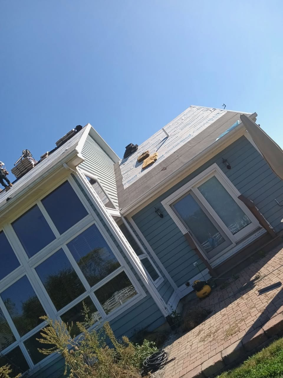 Infinity Home Solutions crew completing siding and roofing project in Michigan