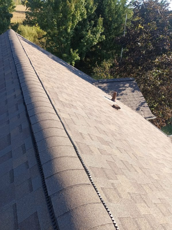 Ridge cap and shingle detail on completed Michigan roof